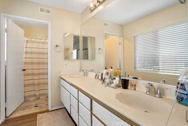 11568 Luanda St, Lakeview Terrace, CA 91342 - bathroom featuring double vanity and wood finished floors