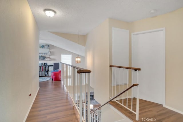 11568 Luanda St, Lakeview Terrace, CA 91342 - hall with an upstairs landing, wood finished floors, and a textured ceiling