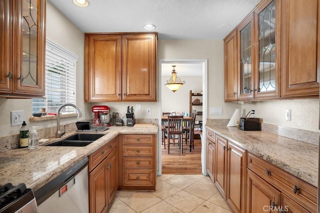 11568 Luanda St, Lakeview Terrace, CA 91342 - kitchen with a sink, brown cabinets, light stone counters, light tile patterned floors, and recessed lighting