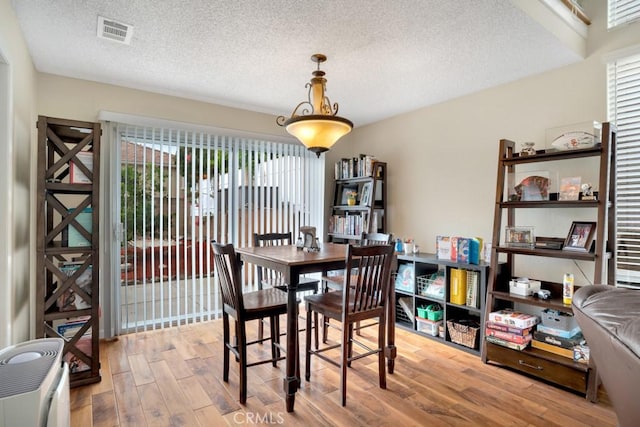 11568 Luanda St, Lakeview Terrace, CA 91342 - dining space with wood finished floors and a textured ceiling