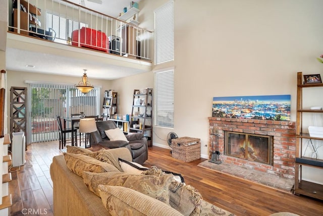 11568 Luanda St, Lakeview Terrace, CA 91342 - living room featuring wood finished floors, a fireplace, baseboards, and a towering ceiling