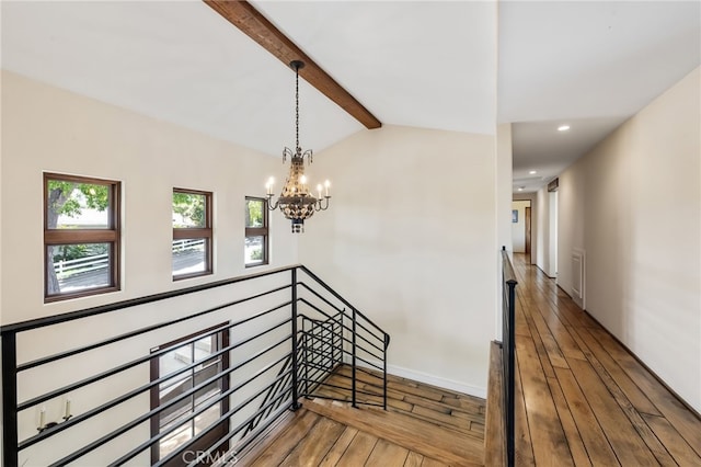 stairway featuring lofted ceiling with beams, baseboards, recessed lighting, a chandelier, and hardwood / wood-style floors