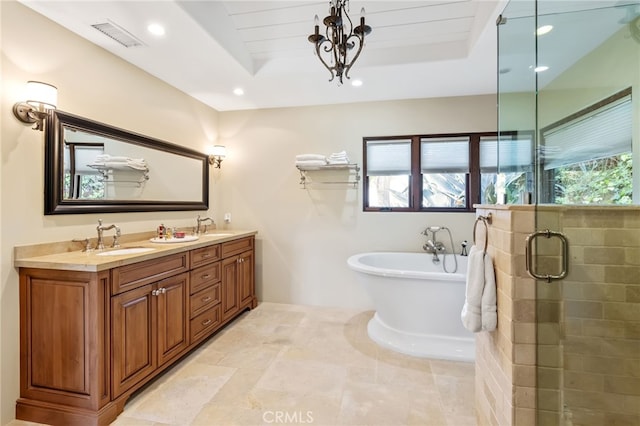 bathroom with a shower stall, a soaking tub, visible vents, and a sink
