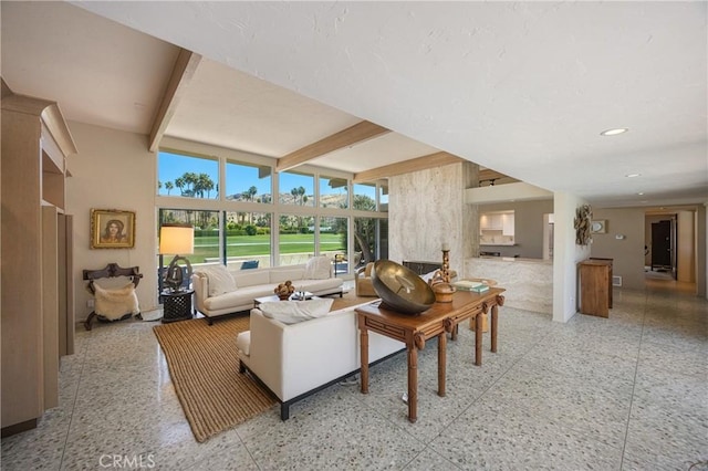 living area with beamed ceiling and recessed lighting