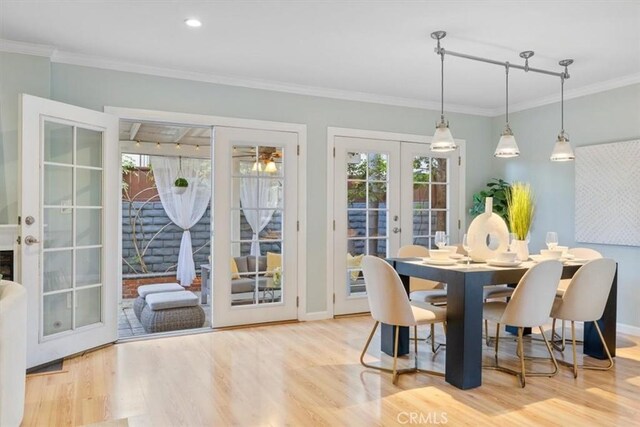 dining space featuring a wealth of natural light, french doors, and wood finished floors