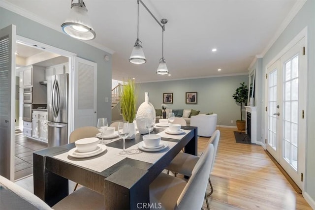 dining space featuring light wood-style flooring, baseboards, recessed lighting, and crown molding
