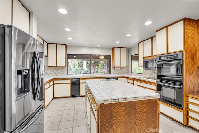 kitchen featuring recessed lighting, backsplash, a center island, and stainless steel appliances