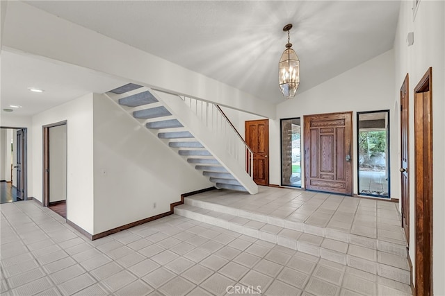 foyer with vaulted ceiling, light tile patterned floors, baseboards, a notable chandelier, and stairs