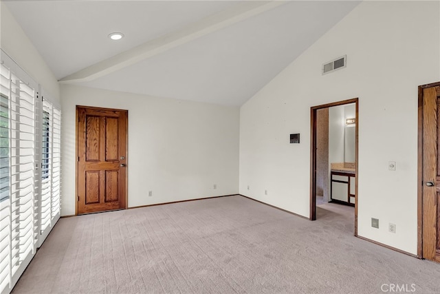 unfurnished bedroom featuring visible vents, carpet flooring, baseboards, and high vaulted ceiling