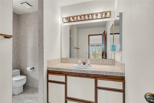 full bathroom featuring vanity, tile patterned floors, toilet, and visible vents