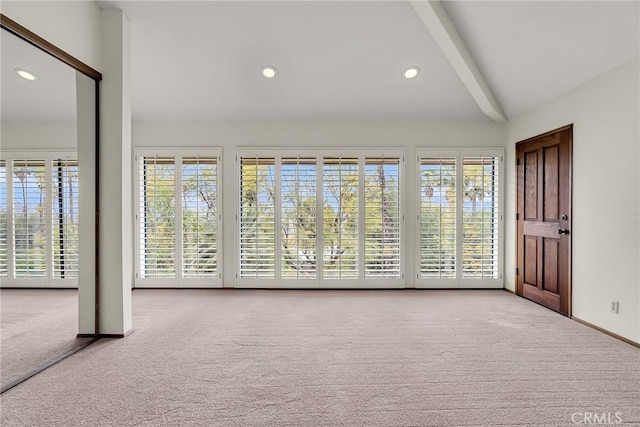 entrance foyer with carpet floors, recessed lighting, baseboards, and vaulted ceiling with beams