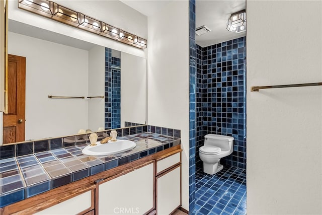 bathroom featuring toilet, tile patterned floors, and vanity