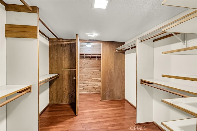 spacious closet featuring light wood finished floors