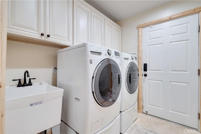 washroom with separate washer and dryer, a sink, and cabinet space
