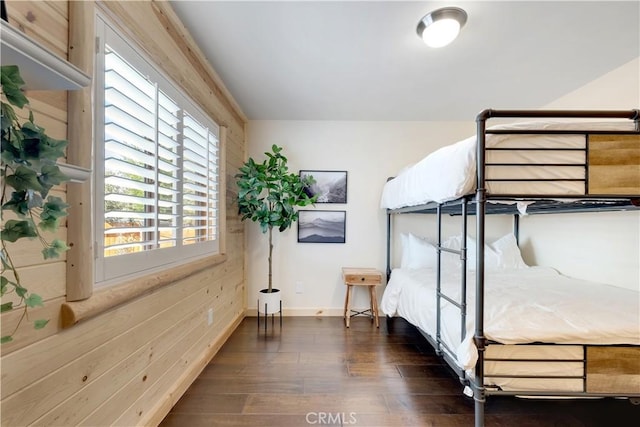 bedroom with baseboards and dark wood-style flooring