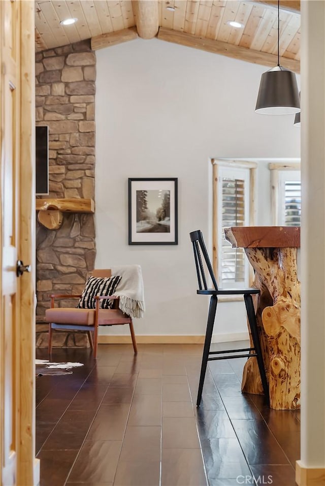 interior space with wood ceiling, lofted ceiling with beams, and baseboards