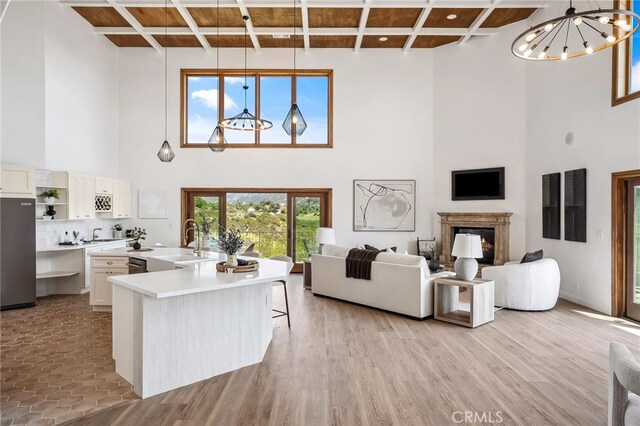 4385 Rainbow Vista Dr, Fallbrook, CA 92028 - living area with a high ceiling, a chandelier, coffered ceiling, a fireplace, and beamed ceiling