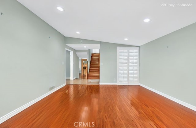 2530 Glenstone Ave, Hacienda Heights, CA 91745 - unfurnished living room featuring lofted ceiling, stairs, wood finished floors, baseboards, and recessed lighting