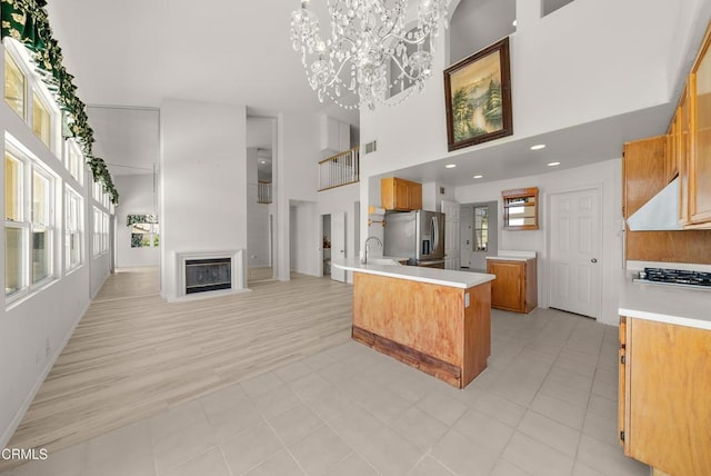 964 Vista Pointe Pl, Santa Paula, CA 93060 - kitchen featuring open floor plan, an inviting chandelier, a high ceiling, light countertops, and appliances with stainless steel finishes