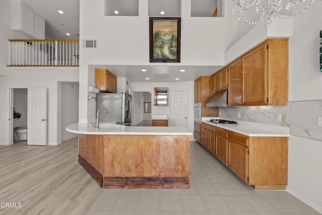 964 Vista Pointe Pl, Santa Paula, CA 93060 - kitchen featuring a high ceiling, stainless steel appliances, visible vents, and a sink