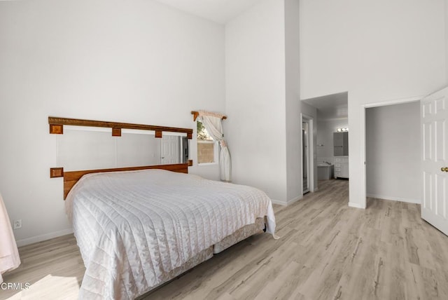 964 Vista Pointe Pl, Santa Paula, CA 93060 - bedroom featuring a high ceiling, light wood-style floors, ensuite bathroom, and baseboards
