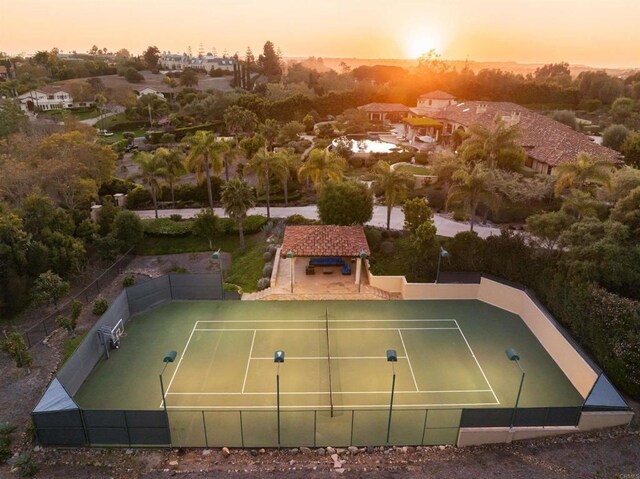 view of tennis court featuring fence