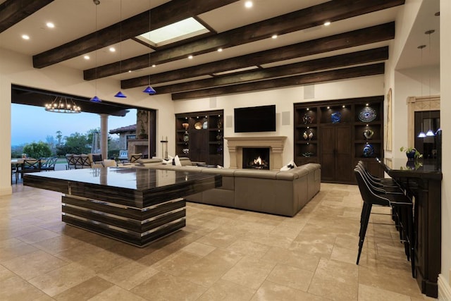 interior space featuring decorative light fixtures, a warm lit fireplace, beamed ceiling, and recessed lighting