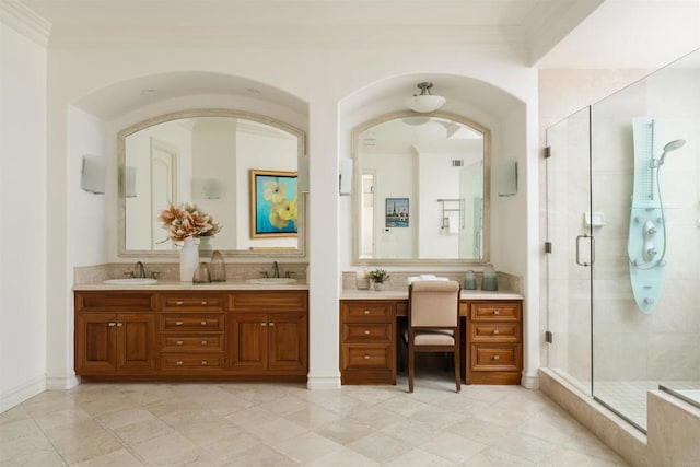 bathroom featuring a sink, a shower stall, and ornamental molding