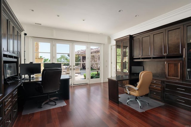 office space with crown molding, built in desk, french doors, dark wood-type flooring, and visible vents