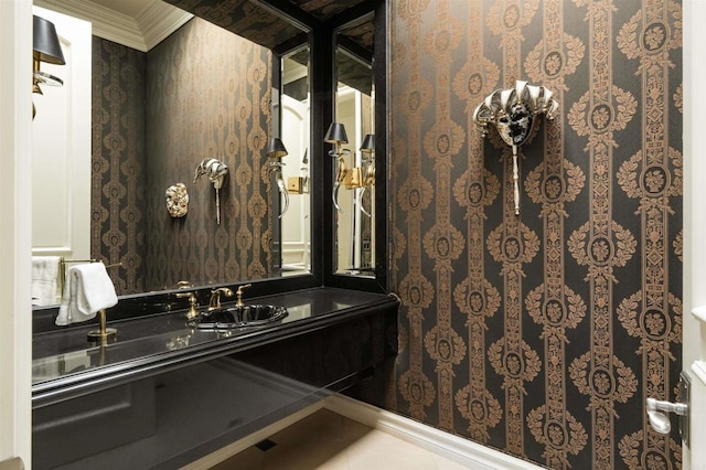 bathroom with wallpapered walls, crown molding, and vanity