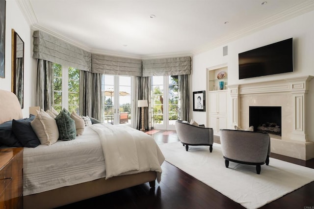 bedroom featuring a premium fireplace, wood finished floors, access to exterior, and ornamental molding