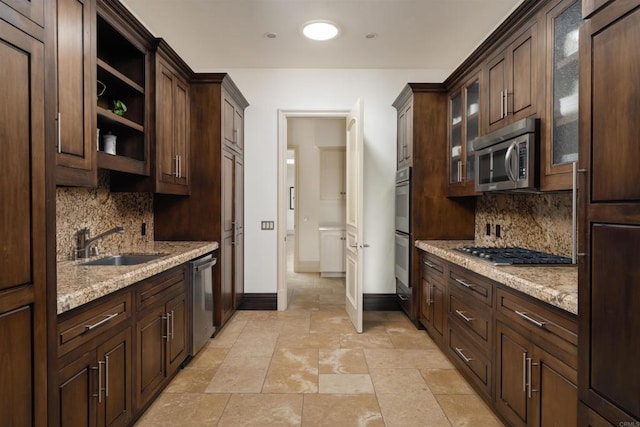 kitchen featuring a sink, dark brown cabinets, baseboards, open shelves, and appliances with stainless steel finishes