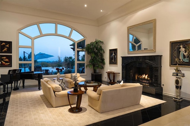 living area with a fireplace, recessed lighting, ornamental molding, and a healthy amount of sunlight