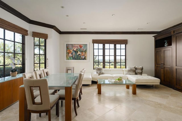 dining area with plenty of natural light and crown molding