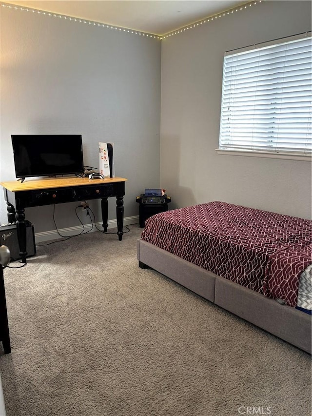 carpeted bedroom with baseboards