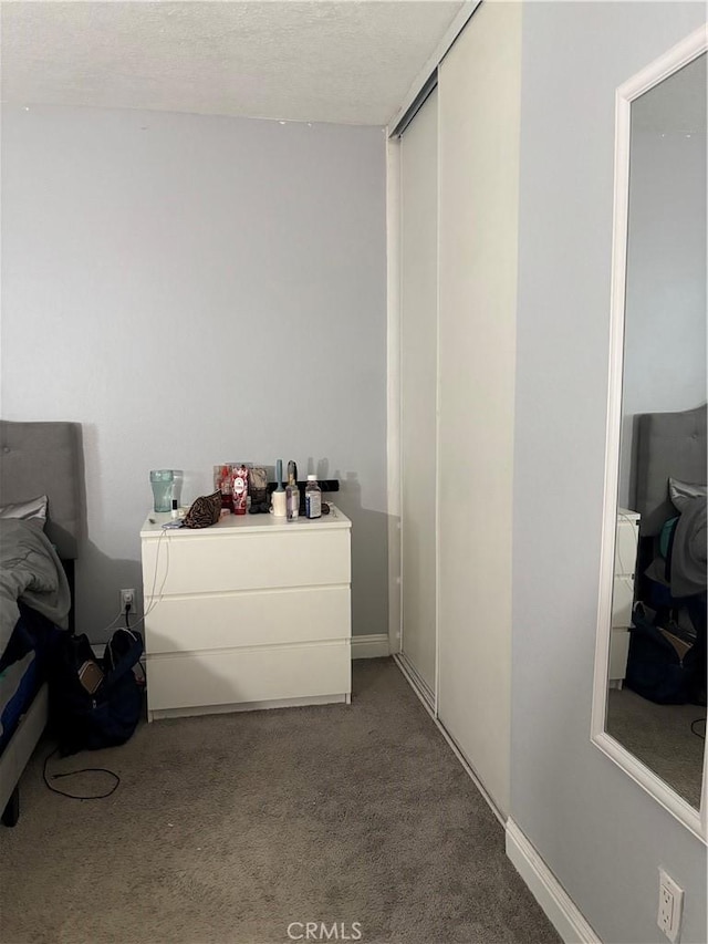 bedroom featuring carpet and a textured ceiling