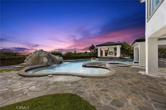 view of pool with a fenced in pool, a gazebo, a patio, and an in ground hot tub