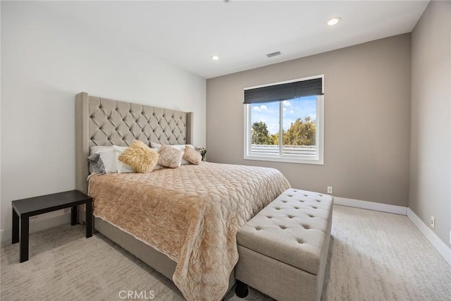 carpeted bedroom featuring recessed lighting, visible vents, and baseboards