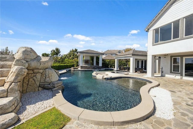 outdoor pool with a gazebo, an in ground hot tub, and a patio area