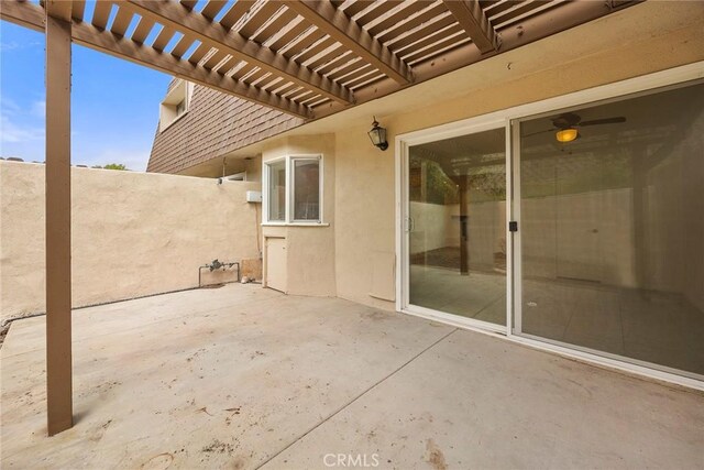 view of patio featuring a pergola and fence