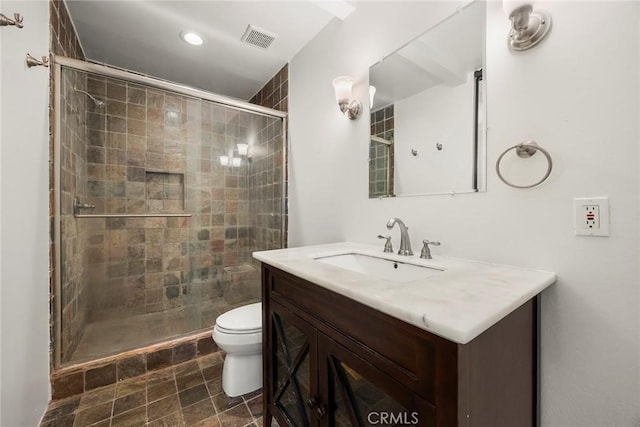 bathroom with recessed lighting, visible vents, toilet, vanity, and a stall shower