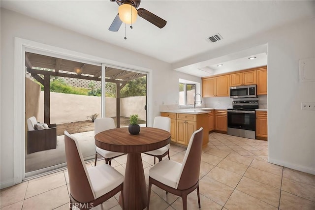 dining space with ceiling fan, baseboards, light tile patterned flooring, and visible vents