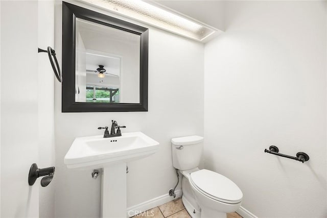 bathroom featuring toilet, tile patterned floors, and baseboards