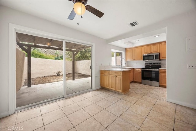kitchen featuring a sink, light tile patterned flooring, visible vents, light countertops, and appliances with stainless steel finishes