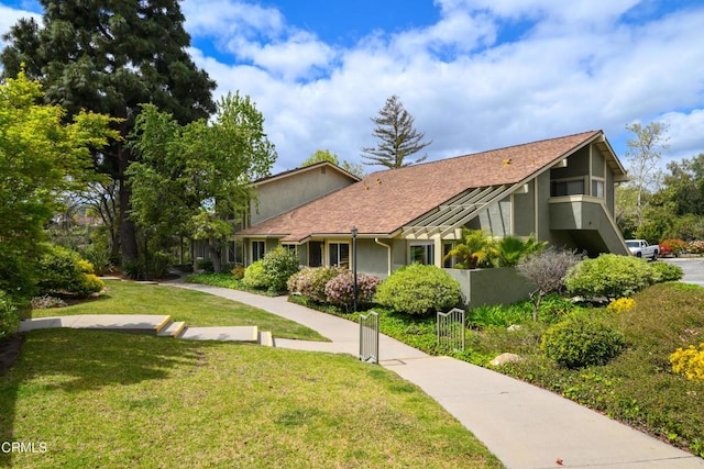 599 Rio Grande Cir, Thousand Oaks, CA 91360 - exterior space with stucco siding, fence, a shingled roof, and a front lawn