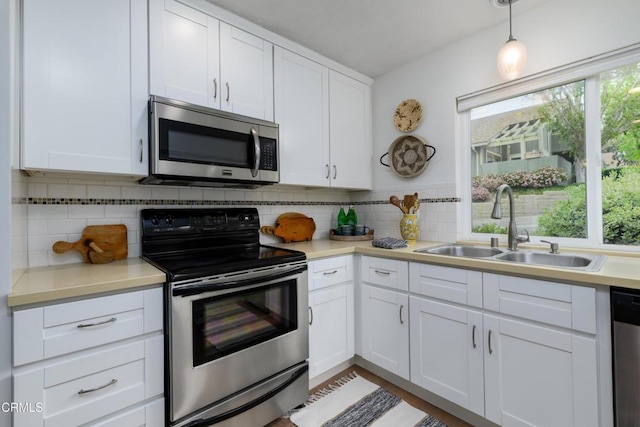 599 Rio Grande Cir, Thousand Oaks, CA 91360 - kitchen with a sink, tasteful backsplash, stainless steel appliances, and white cabinetry