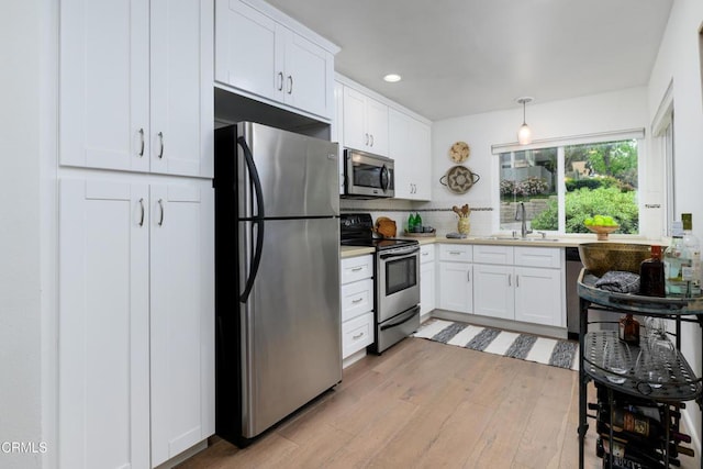 599 Rio Grande Cir, Thousand Oaks, CA 91360 - kitchen featuring tasteful backsplash, stainless steel appliances, light wood-style flooring, and white cabinetry