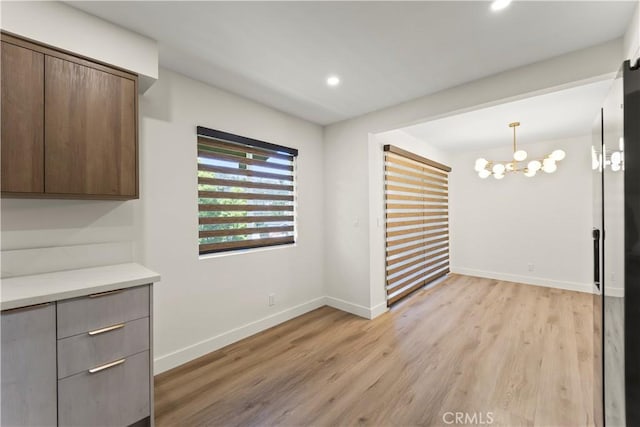 600 W Stocker St Unit 303, Glendale, CA 91202 - unfurnished dining area with light wood-type flooring, a chandelier, baseboards, and recessed lighting