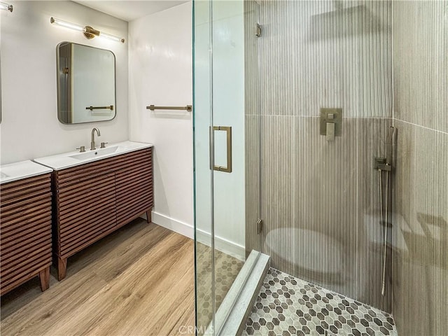 600 W Stocker St Unit 303, Glendale, CA 91202 - bathroom featuring wood finished floors, a shower stall, vanity, and baseboards