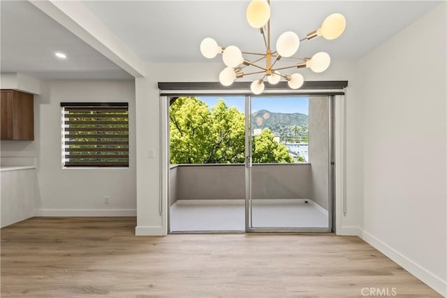 600 W Stocker St Unit 303, Glendale, CA 91202 - unfurnished dining area with a chandelier, baseboards, light wood-style floors, and recessed lighting